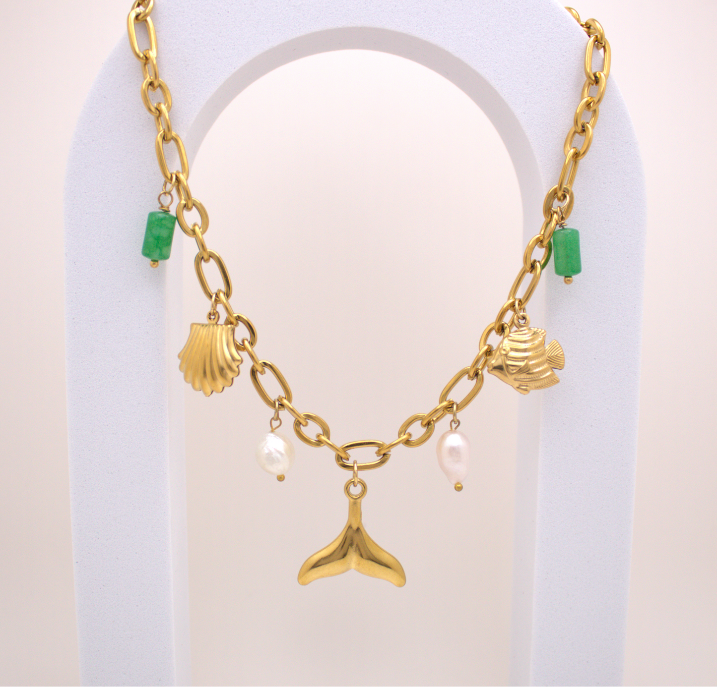 Sea Harmony Necklace in gold with whale tail, pearl, and green stone charms