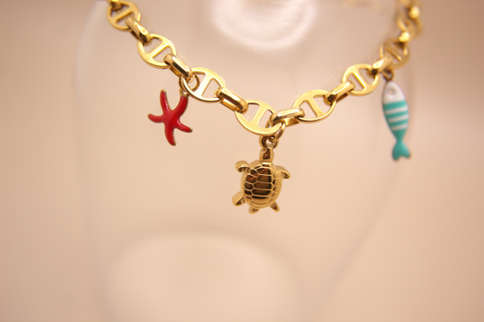 Gold Ocean Voyage Bracelet featuring enamel starfish and fish charms with turtle