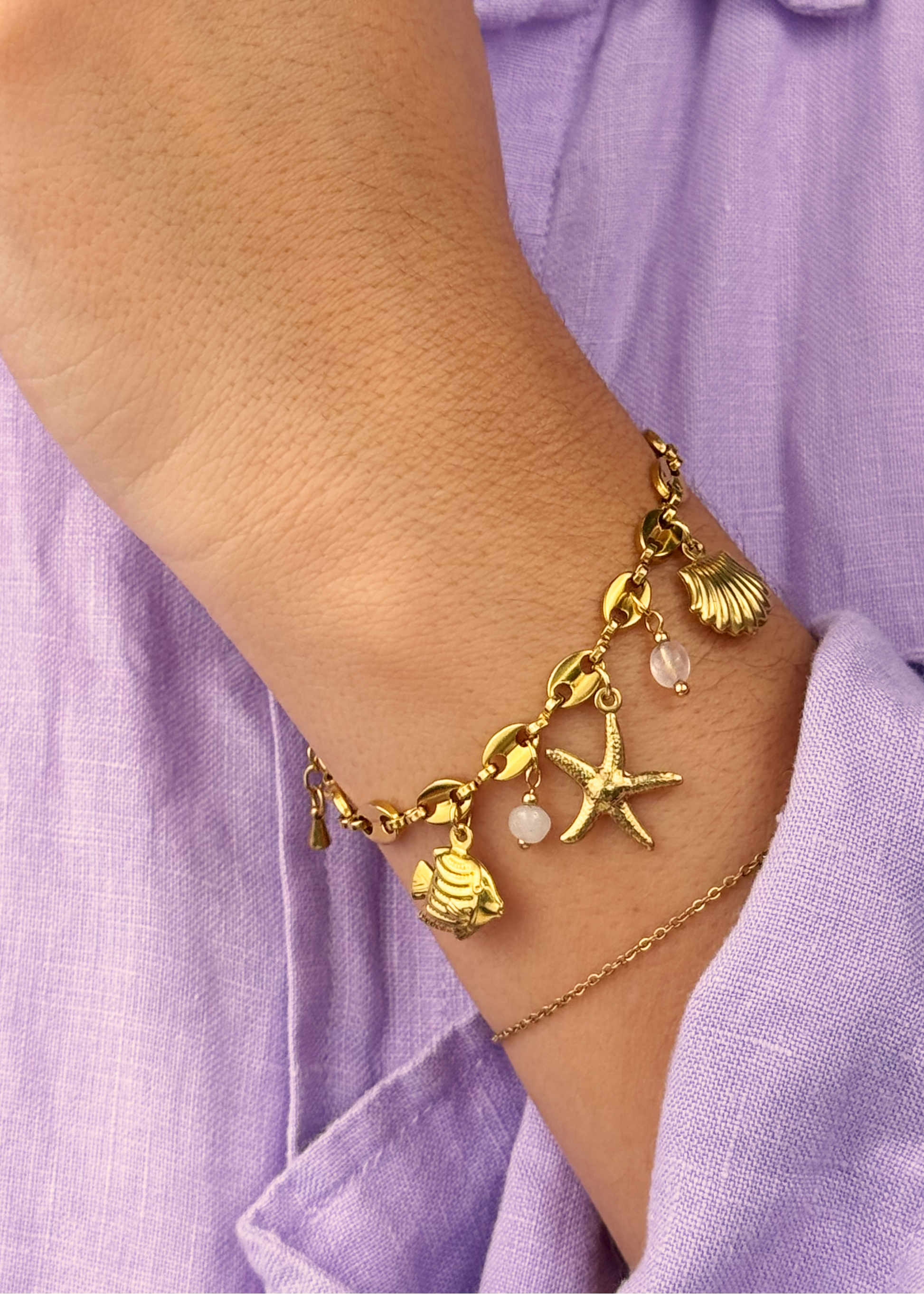Ocean-inspired Pink Tide Bracelet with translucent pink beads and marine charms