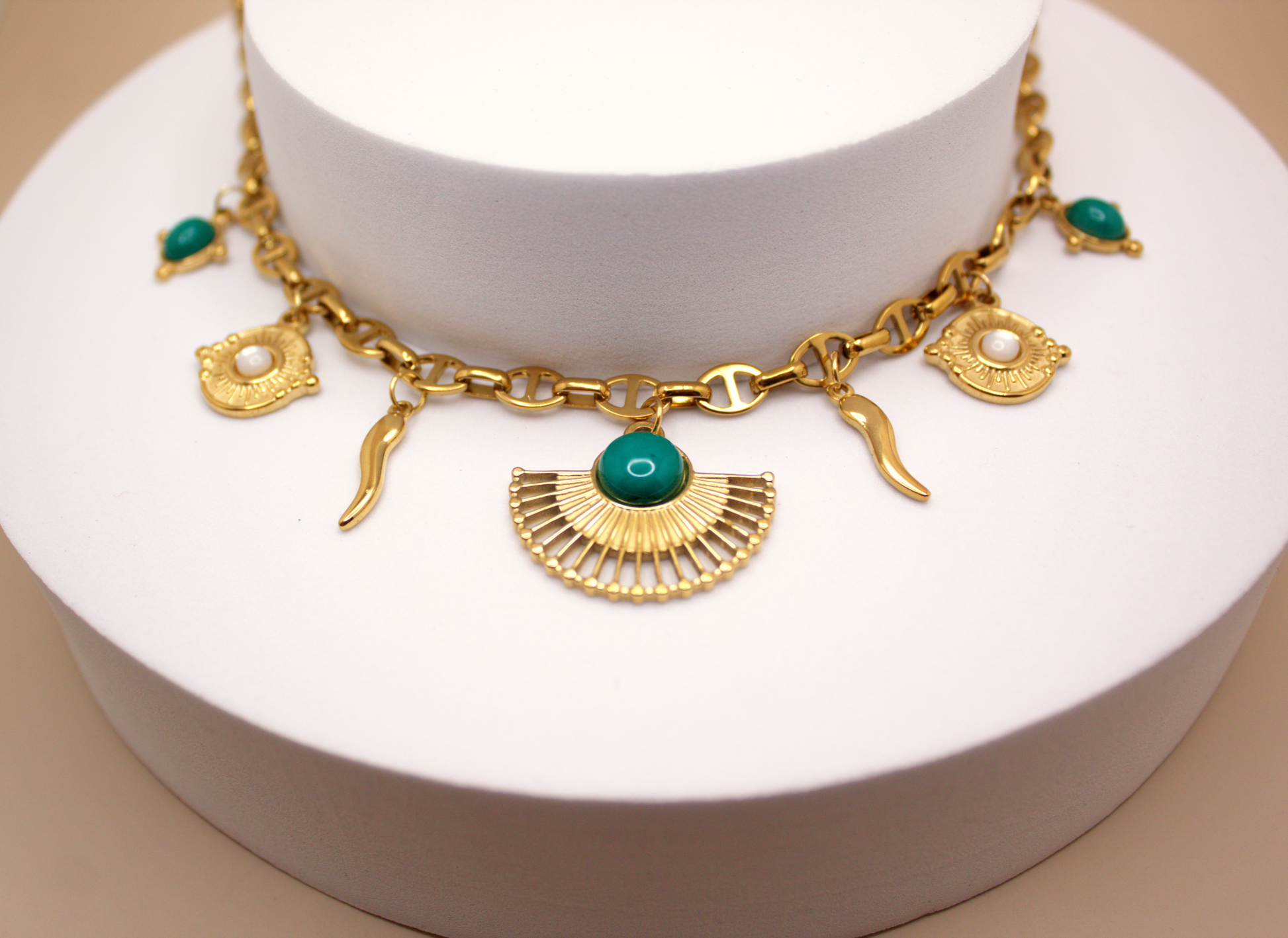 Gold necklace with protective charms, including Italian horn cornicello and sun, PVD stainless steel.