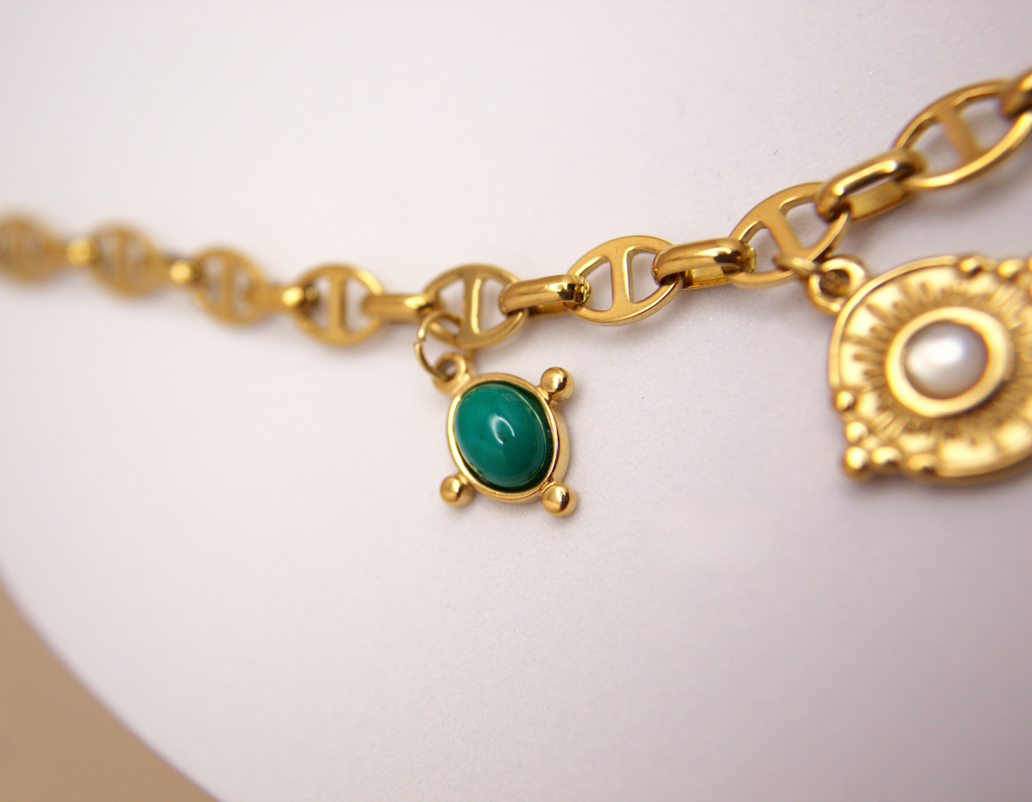 Protective amulet necklace in gold, featuring sun and Italian horn charms, waterproof design.