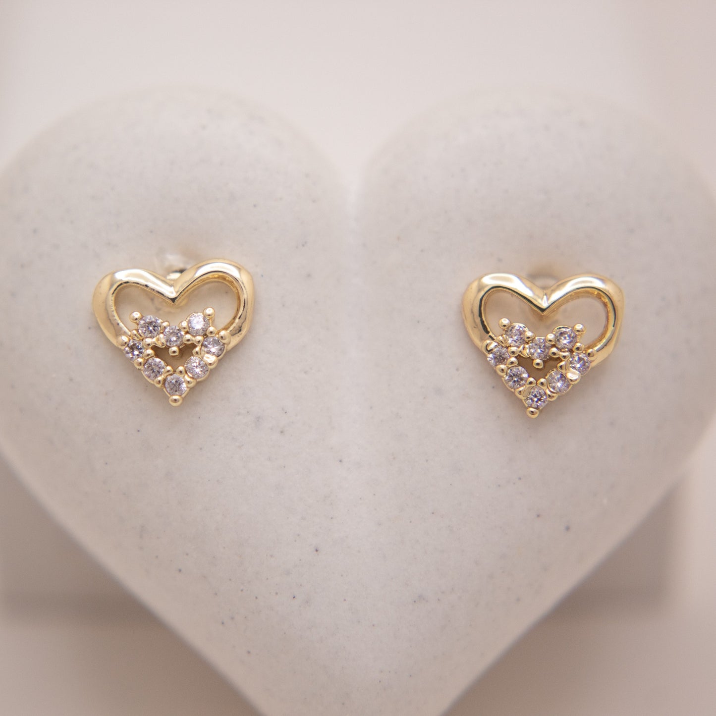 Gold heart stud earrings with high-shine finish by Selva&Co.