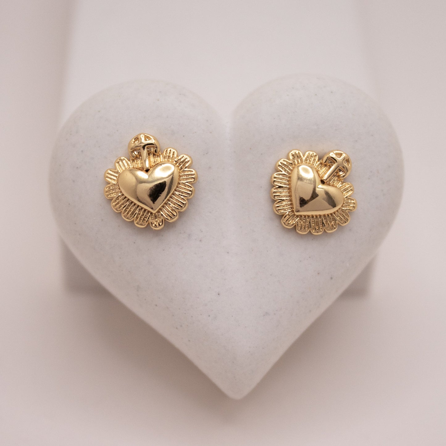 Gold heart stud earrings with cross detail