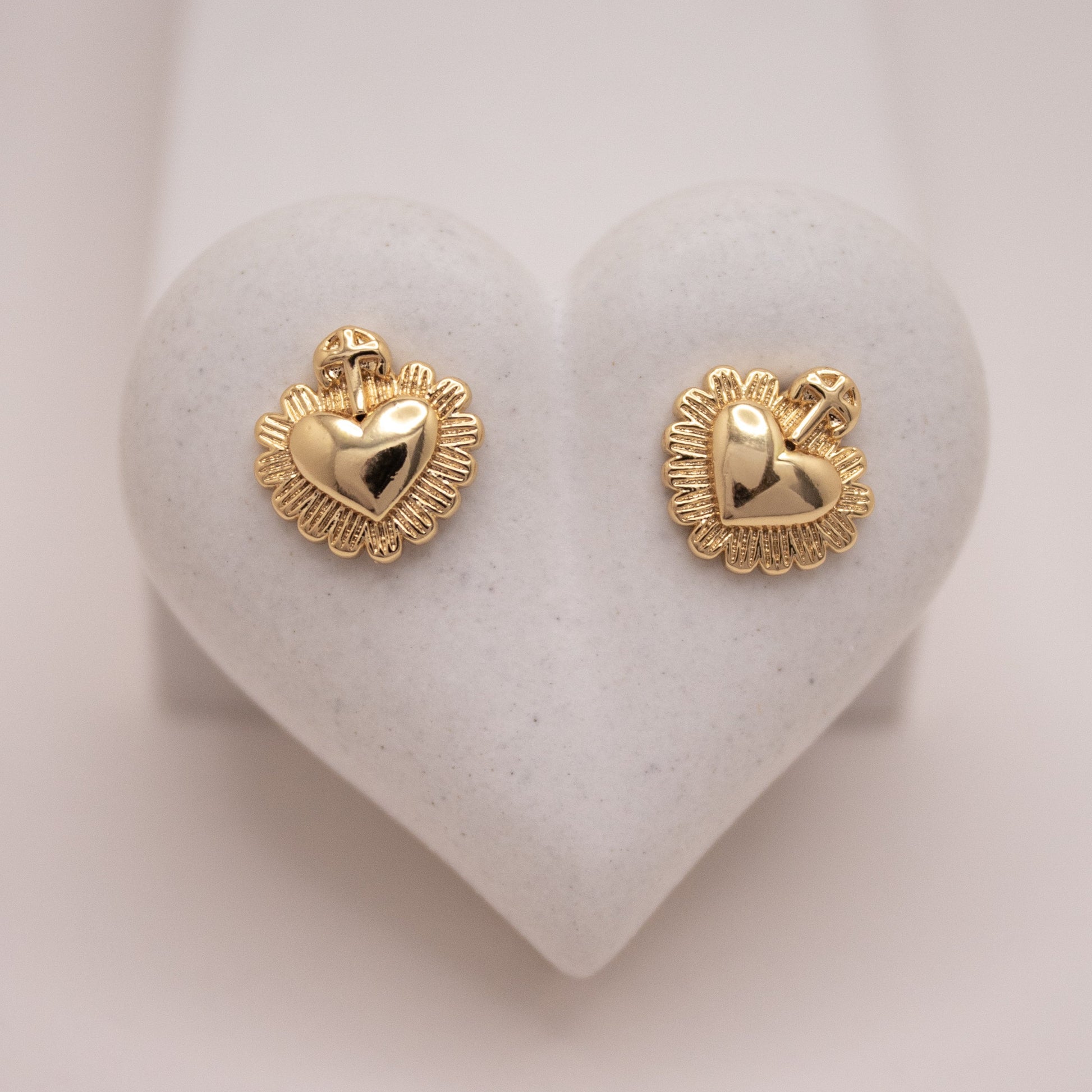 Gold heart stud earrings with cross detail