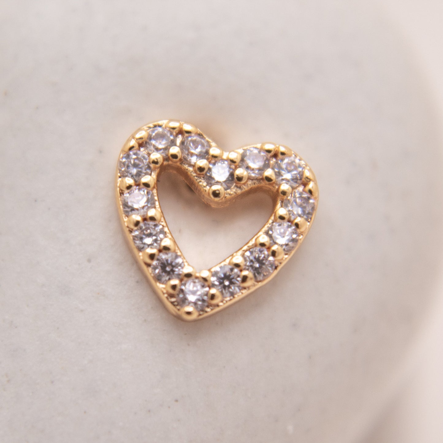 Minimalist gold heart stud earrings close-up