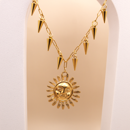 Bold gold necklace with large sun pendant and spike charms, PVD stainless steel design.