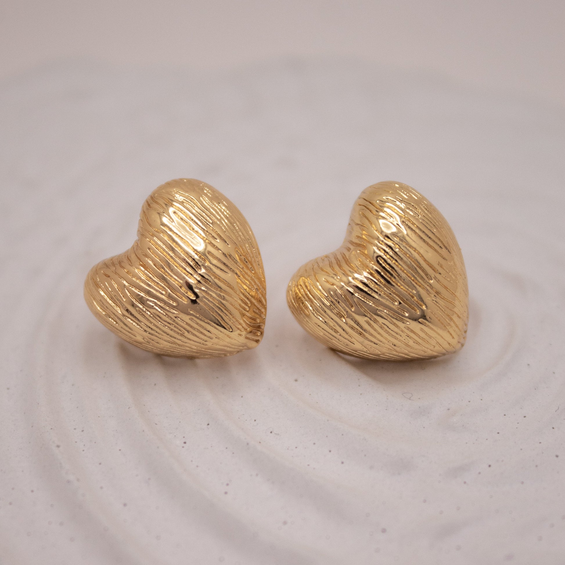Golden Pulse heart studs with sculpted texture