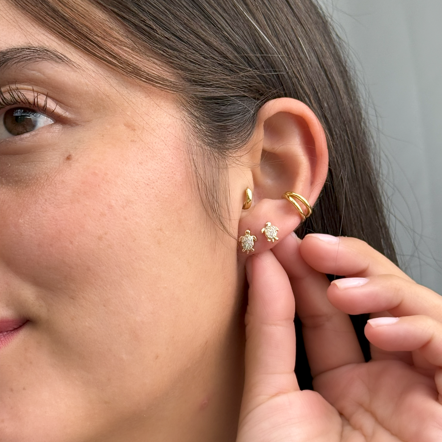 Shiny gold sea turtle studs with sparkly cubic zirconia.