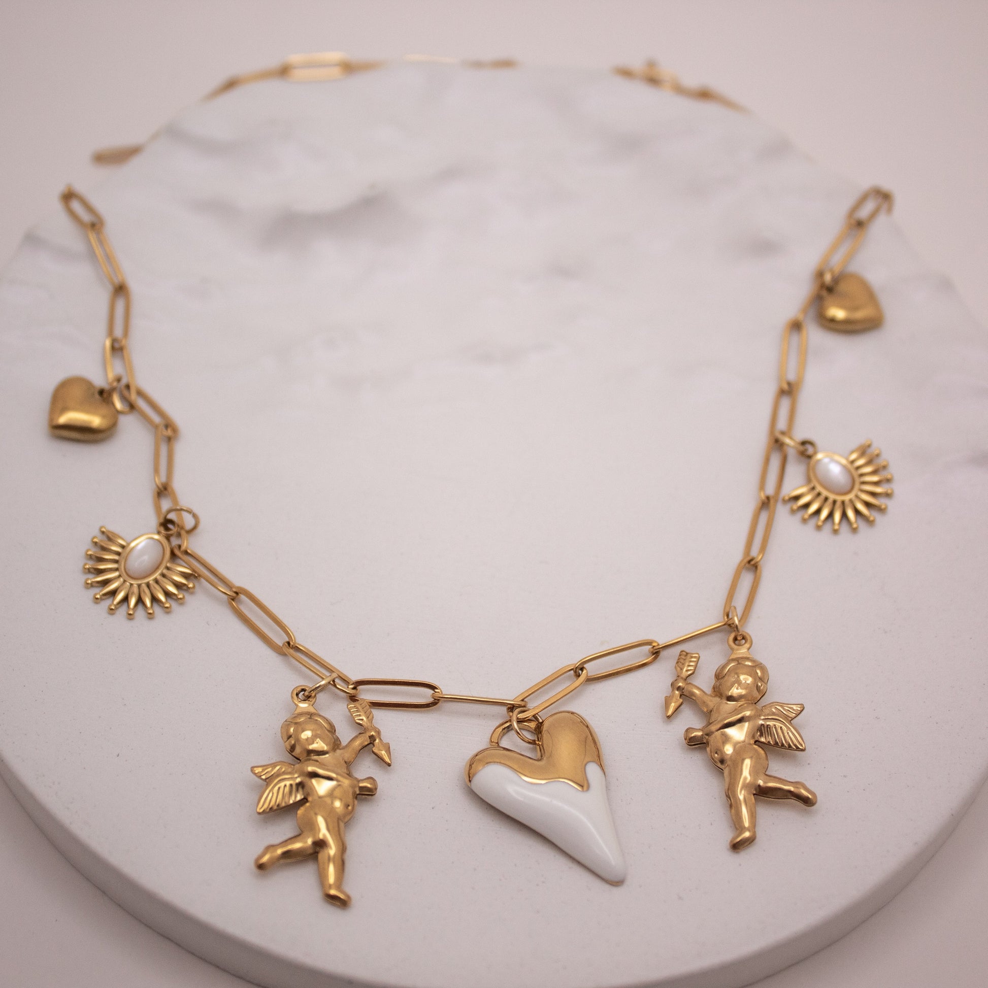 Gold multi-charm necklace with heart and cupid pendants