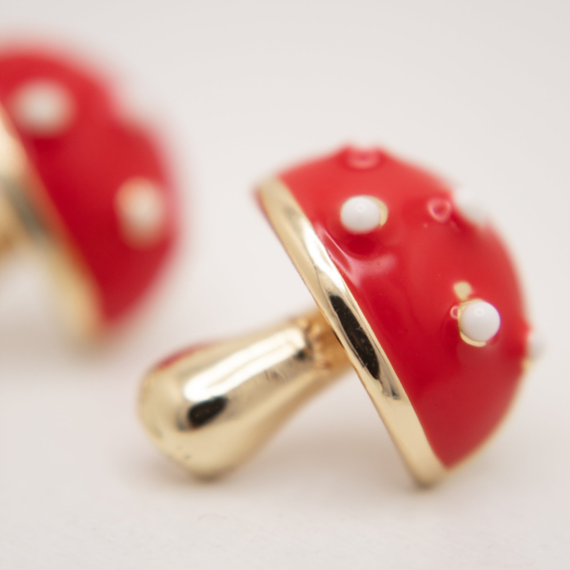 Golden mushroom stud earrings with red and white enamel by Selva