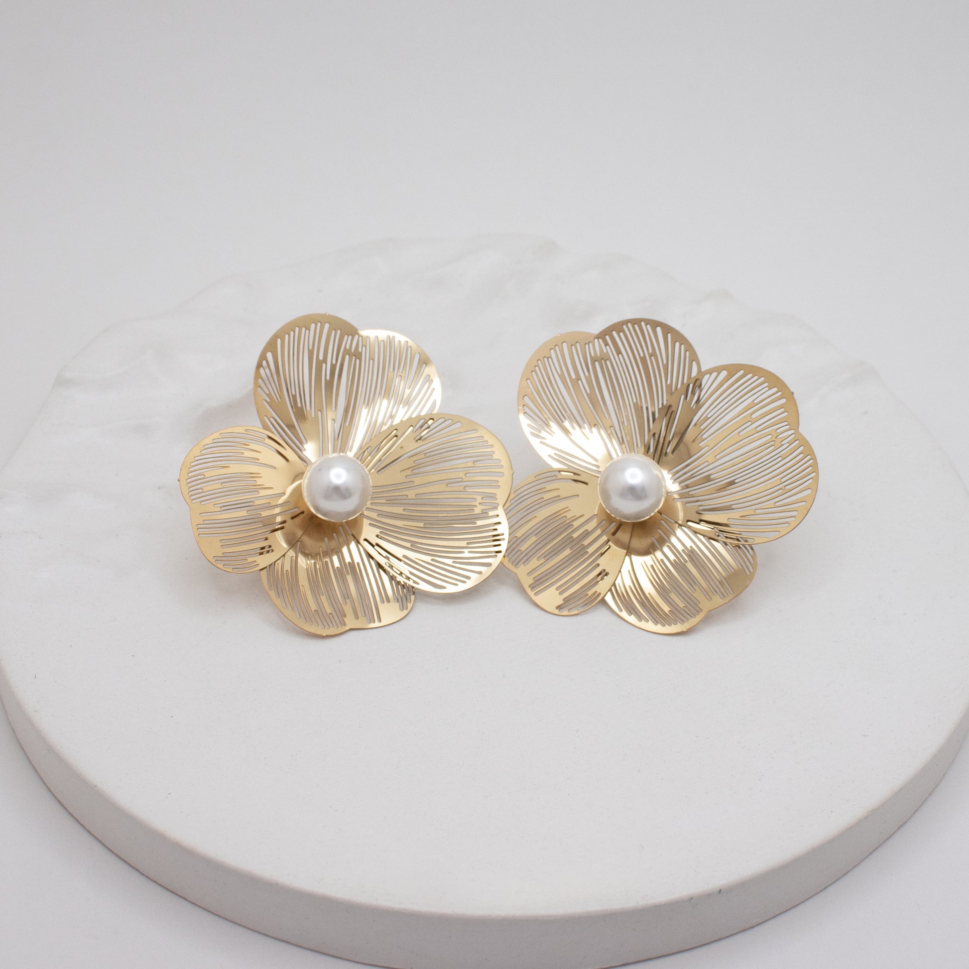 Large gold flower earrings with pearl center