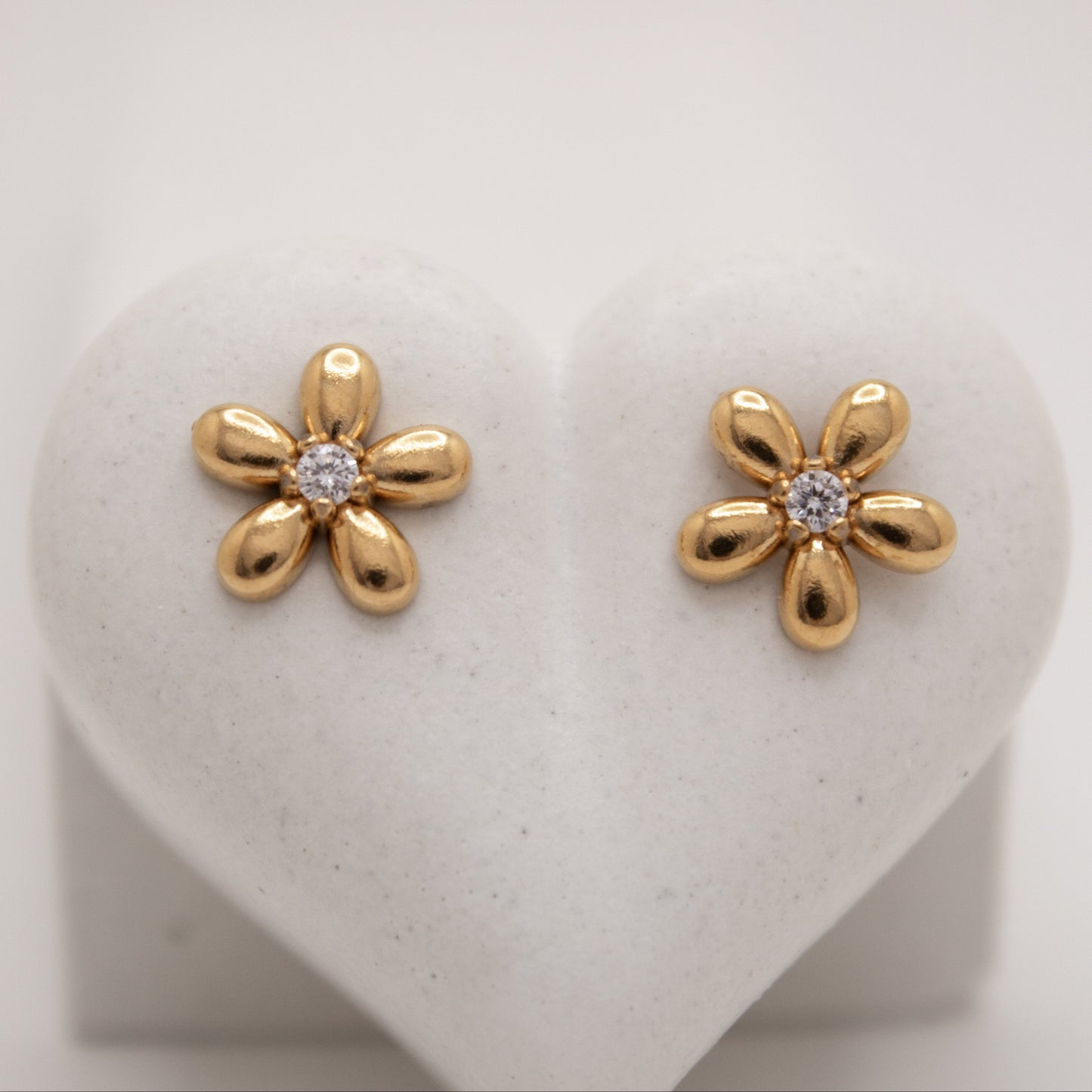 Golden flower stud earrings with white center stone by Selva
