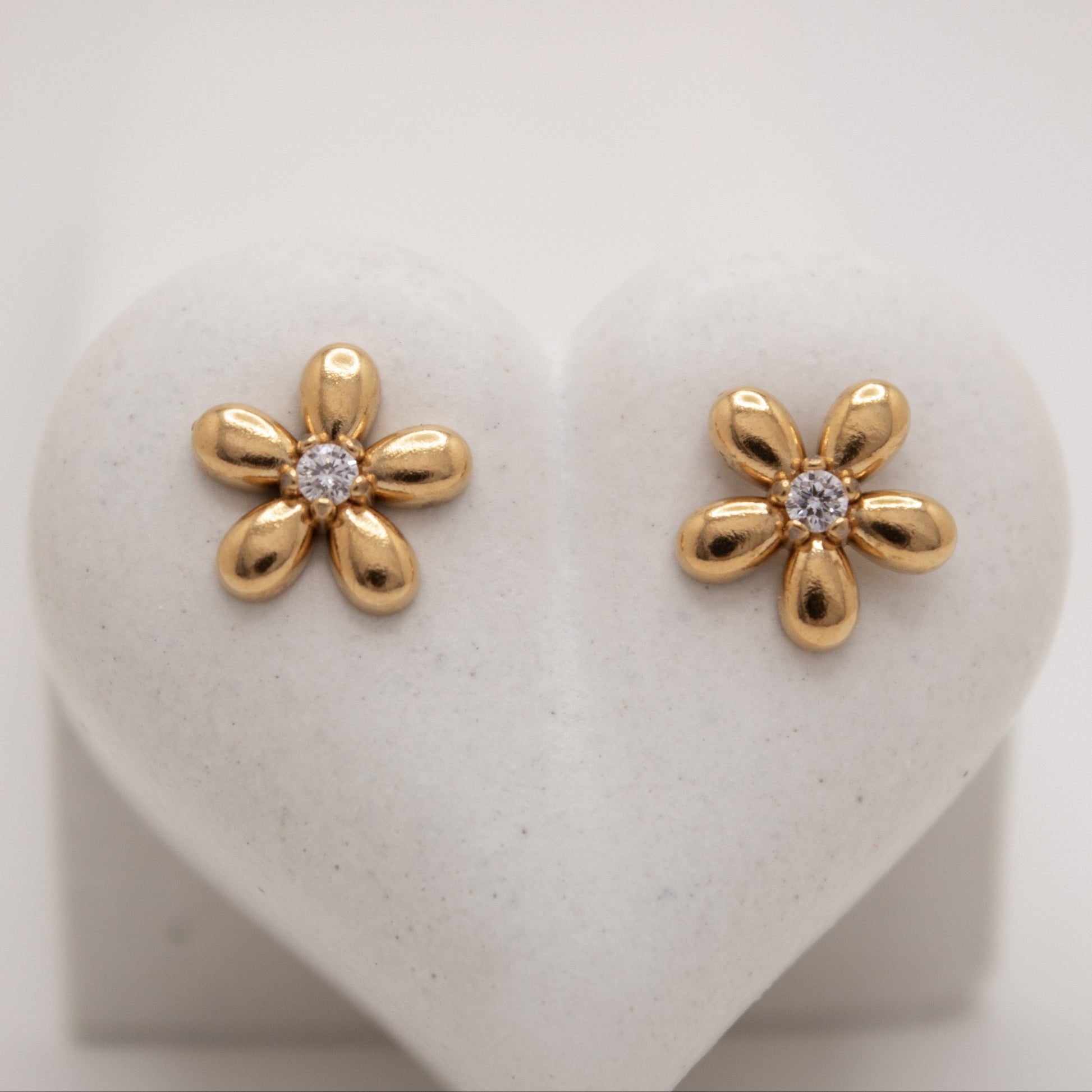Golden flower stud earrings with white center stone by Selva