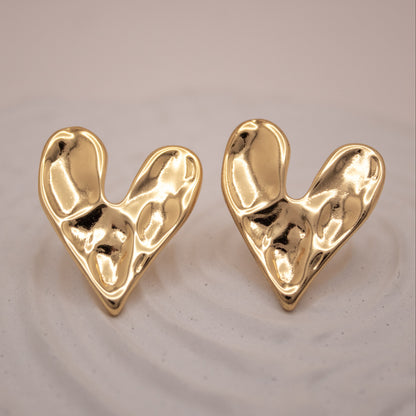 Gold sculptural heart stud earrings with fluid organic design