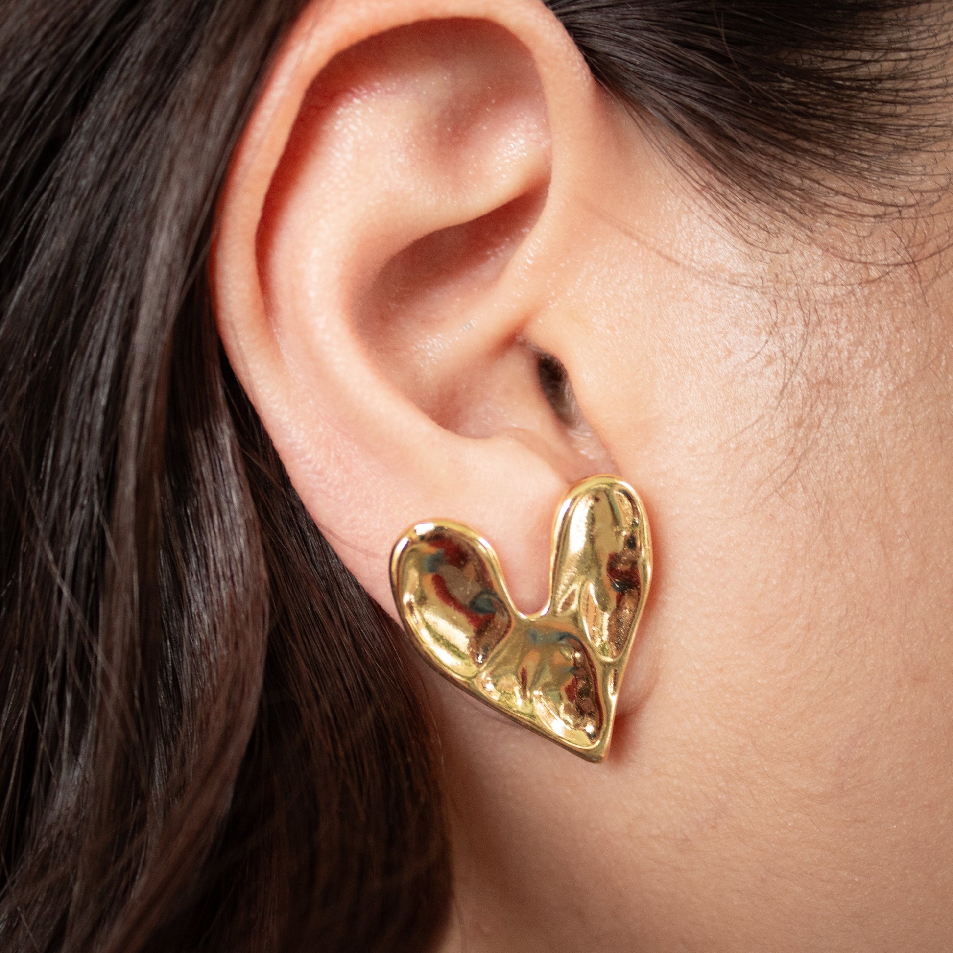 Waterproof gold heart stud earrings with molten finish