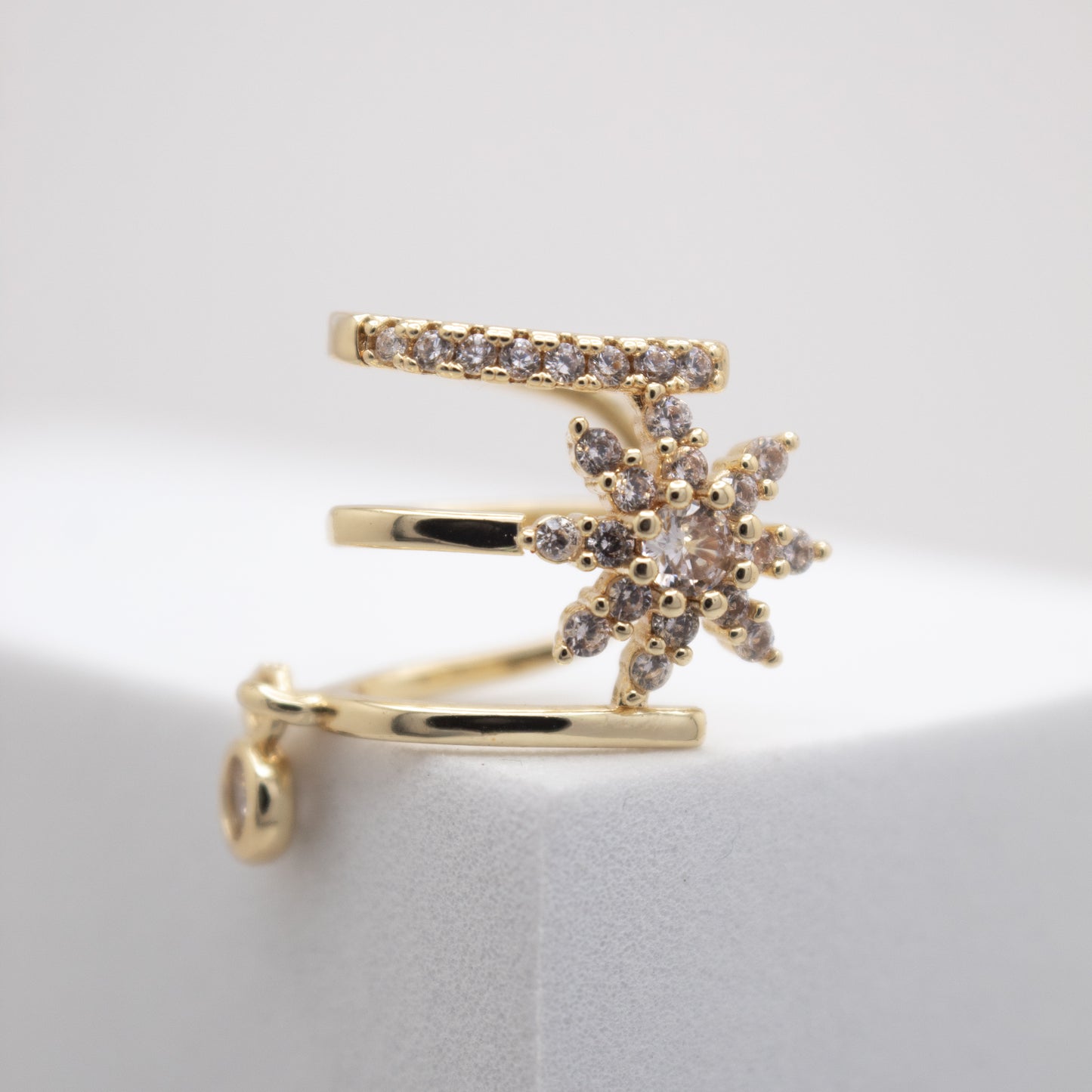 Golden ear cuff with crystal flower design