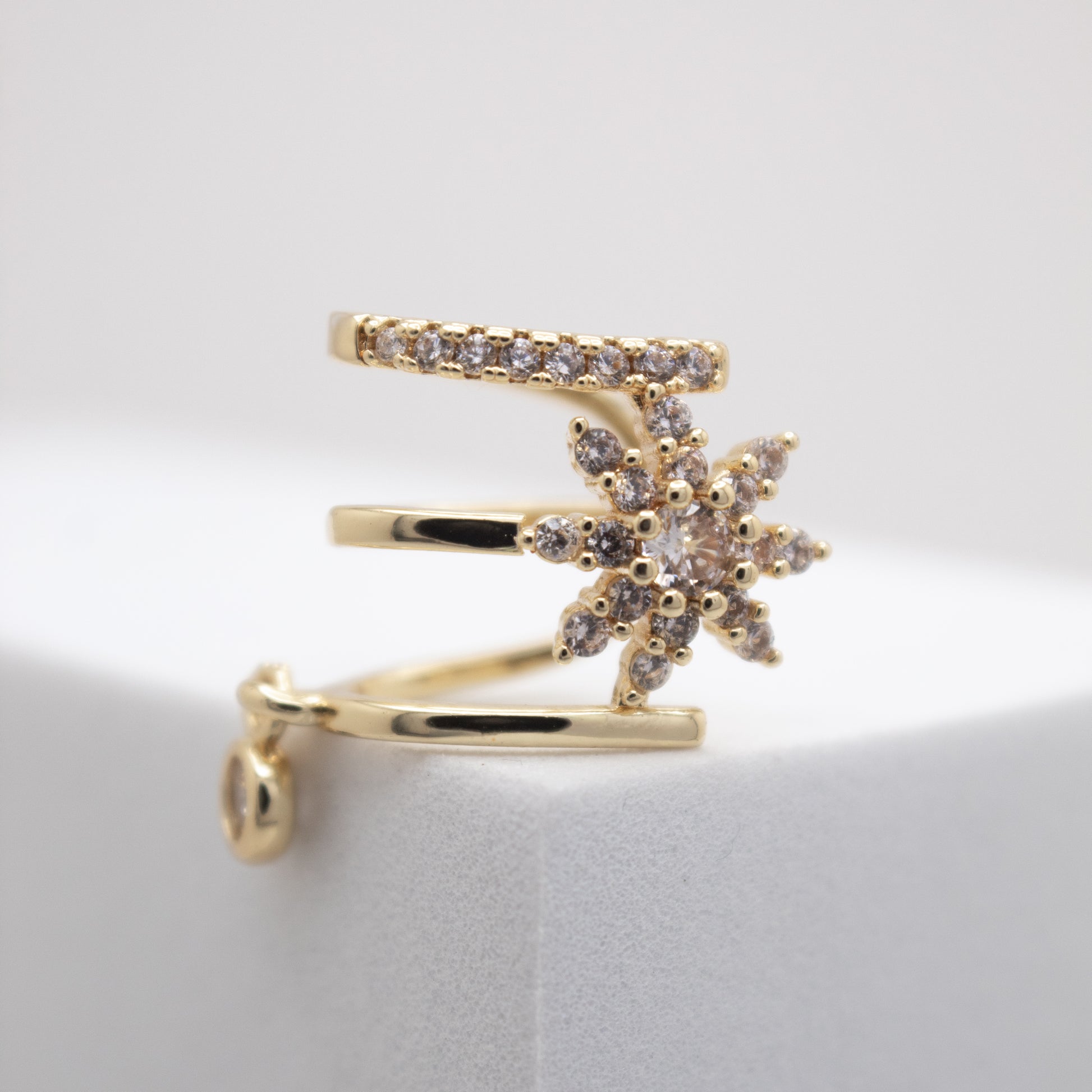 Golden ear cuff with crystal flower design