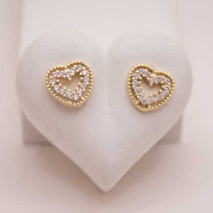 Gold heart stud earrings with crystal inlays in a heart shape