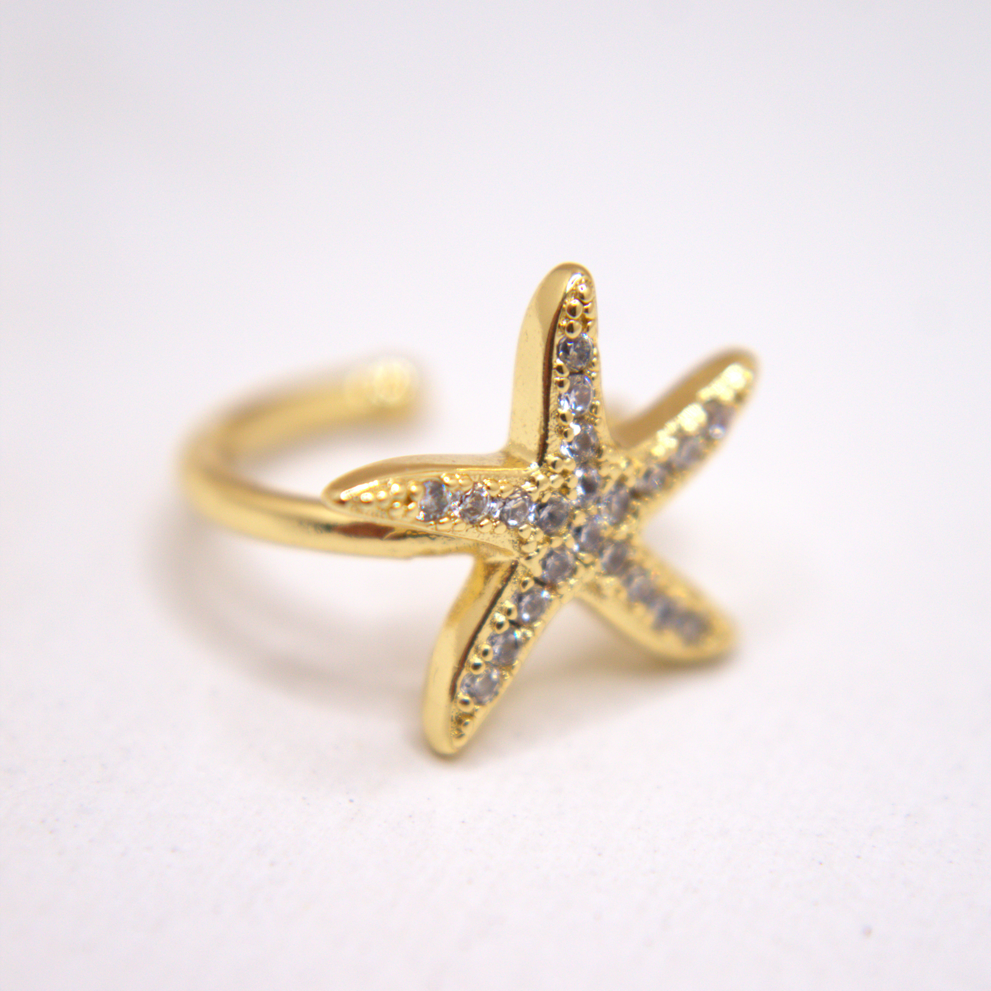 Gold starfish ear cuff with white zirconia accents by Selva&Co.