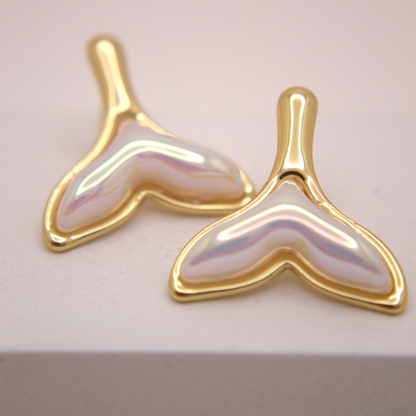 Gold whale tail stud earrings with pearly iridescent finish by Selva&Co.