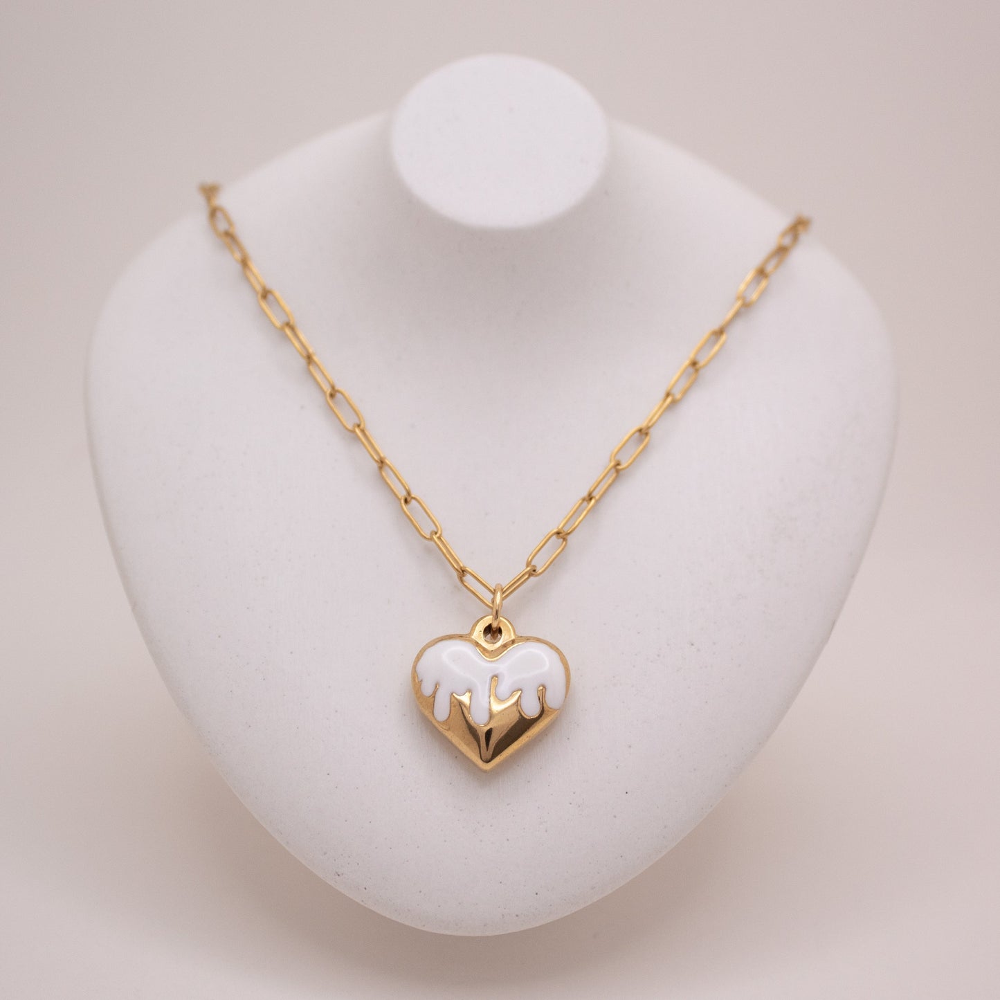 Gold heart necklace with white enamel dripping design