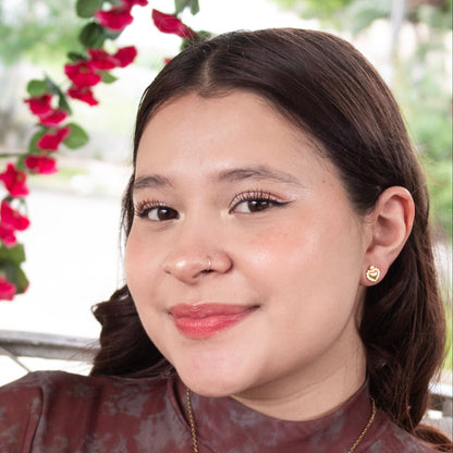 Gold heart and cross stud earrings with high-shine finish.