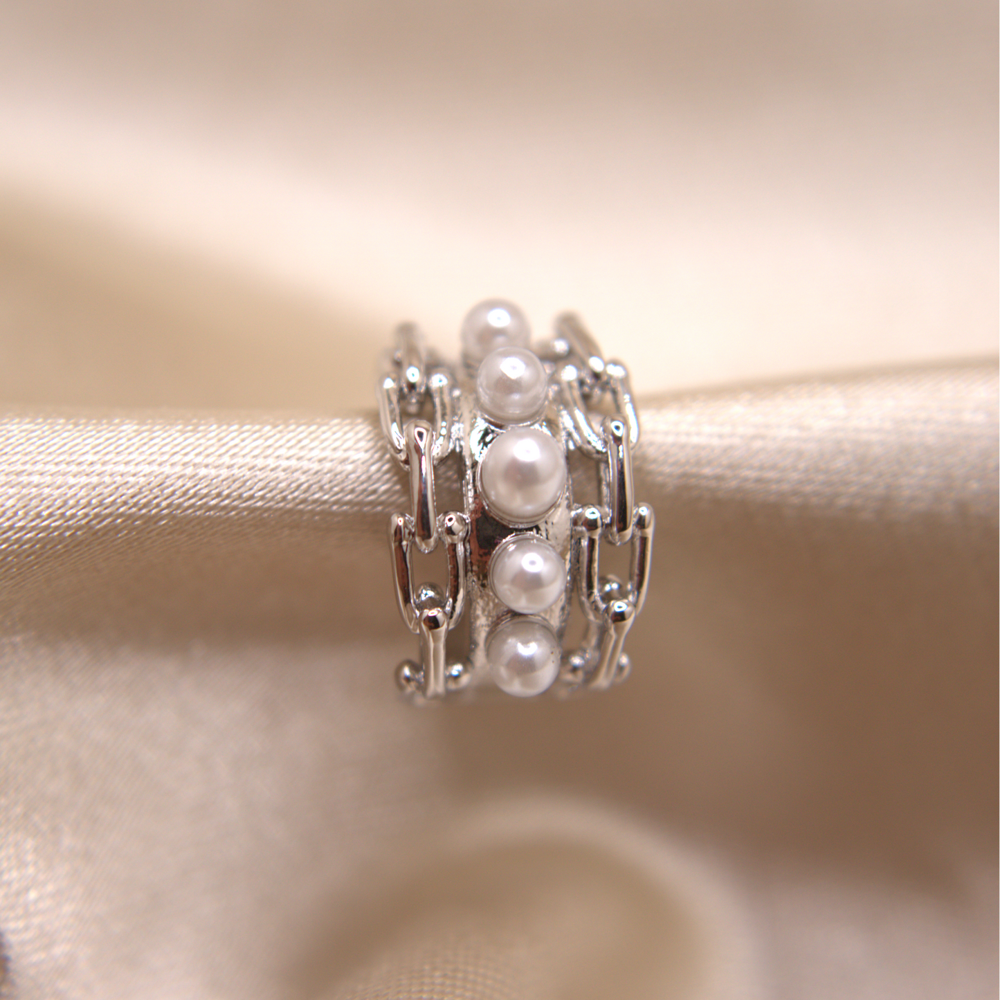 Modern hypoallergenic ear cuff with white pearls and artistic texture.