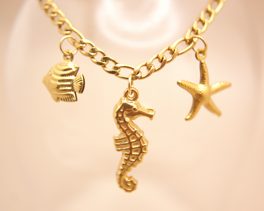 Waterproof PVD gold bracelet featuring seahorse, starfish, and fish pendants