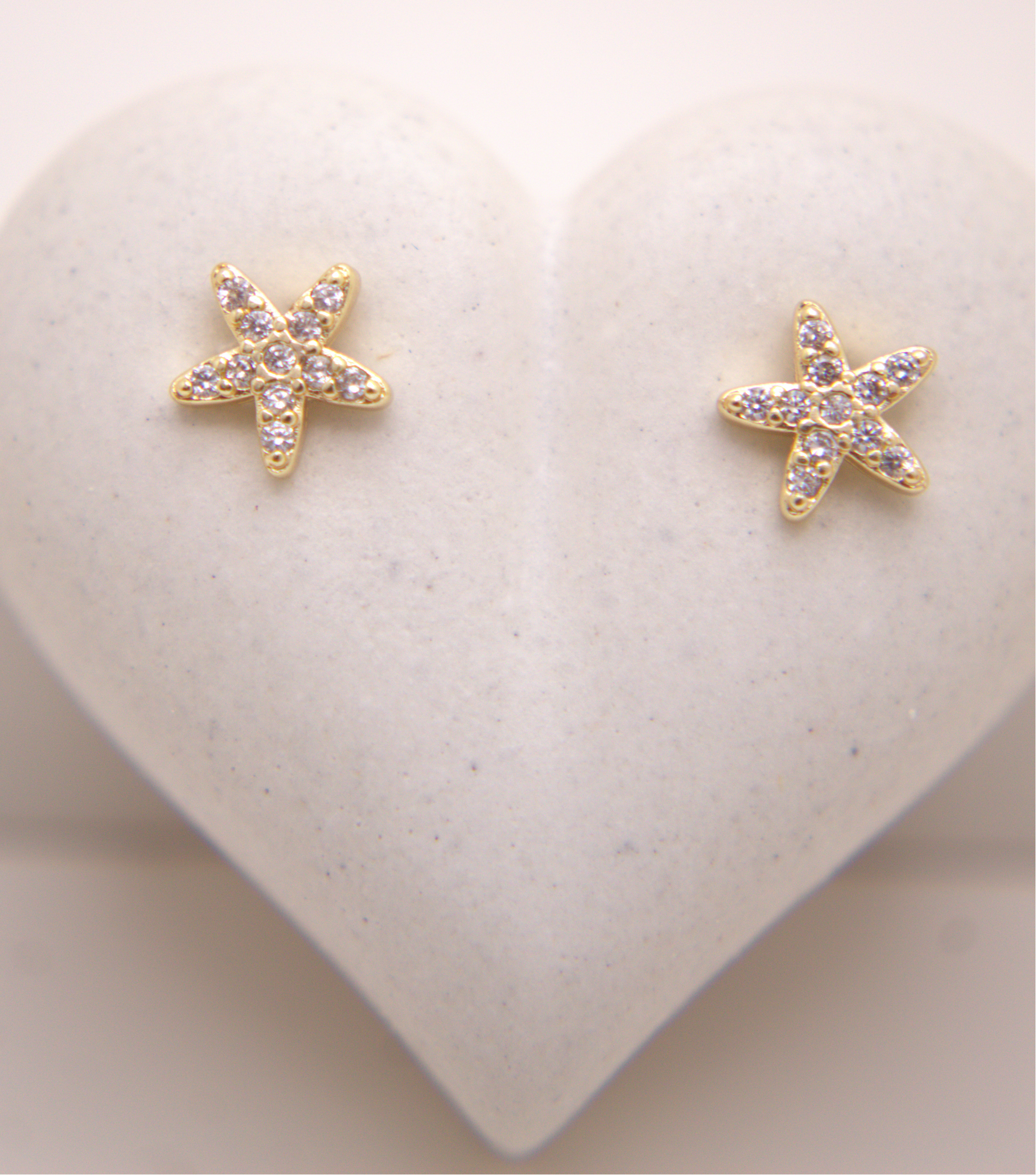 Gold starfish stud earrings with zircon accents by Selva&Co.