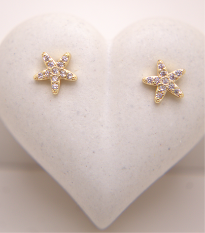 Gold starfish stud earrings with zircon accents by Selva&Co.
