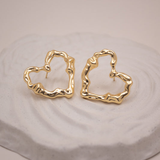 Sculptural gold heart stud earrings with organic shape