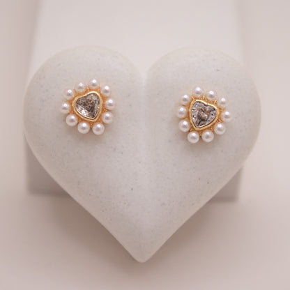 Gold heart stud earrings with crystal center and pearl halo.