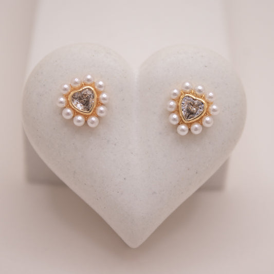 Gold heart stud earrings with crystal center and pearl halo.
