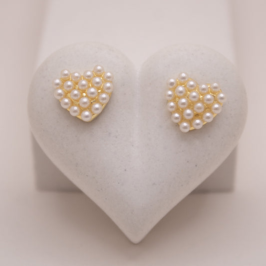 Gold heart-shaped stud earrings with pearl details