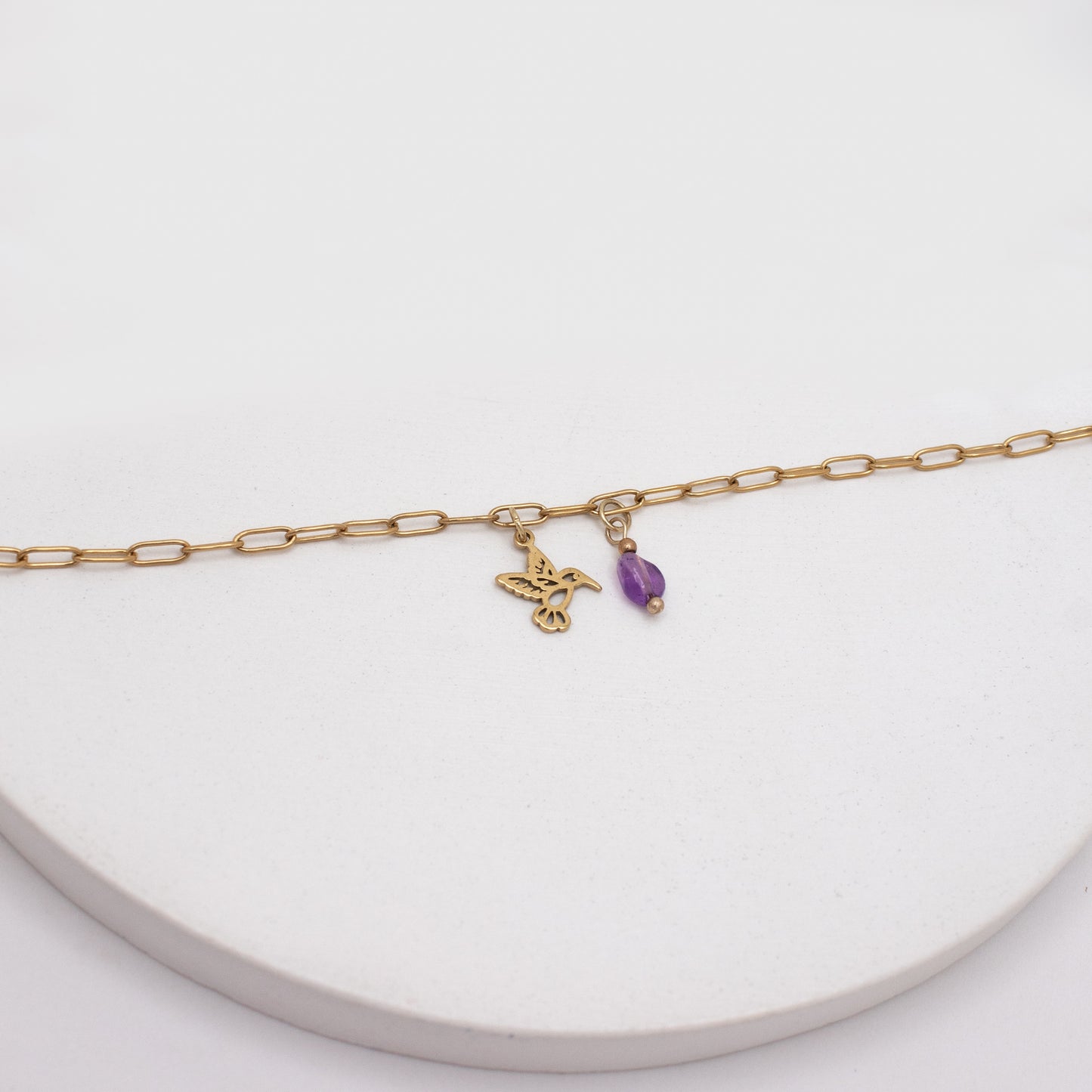 Golden anklet with purple crystal and hummingbird charm