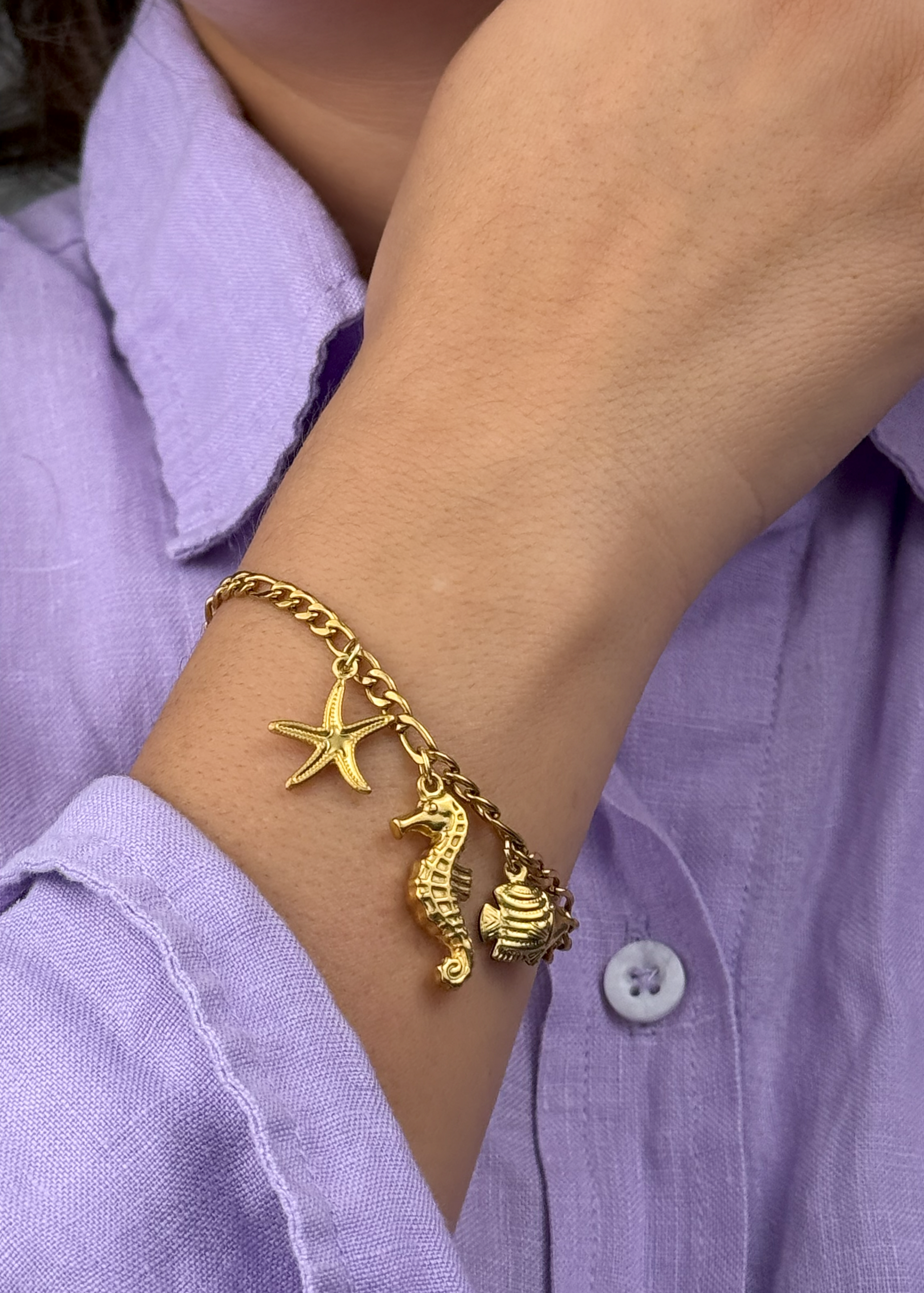 Ocean-inspired gold stainless steel bracelet with marine charms