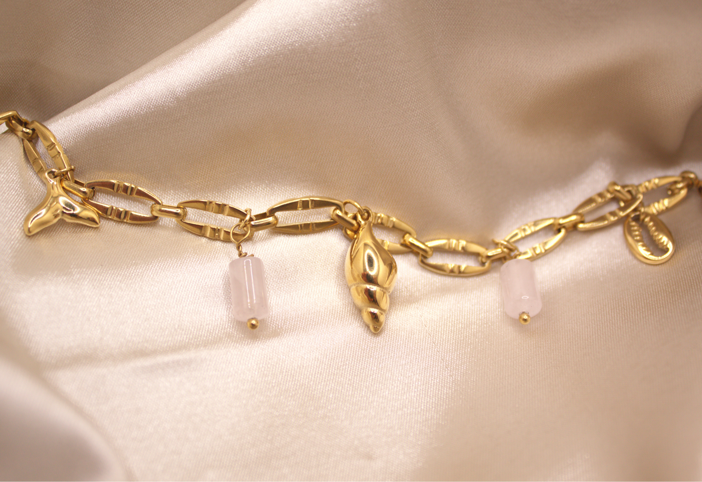 Seashell Dreams Bracelet in gold with seashell, mermaid tail, and white stone charms