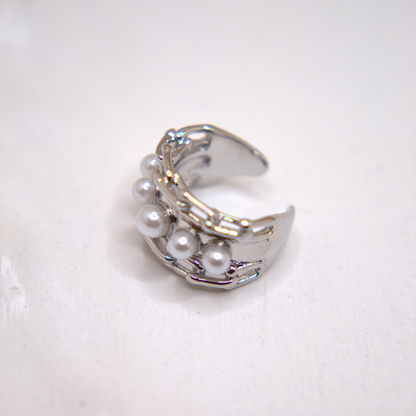 Rhodium-plated ear cuff inspired by ocean waves and timeless grace.