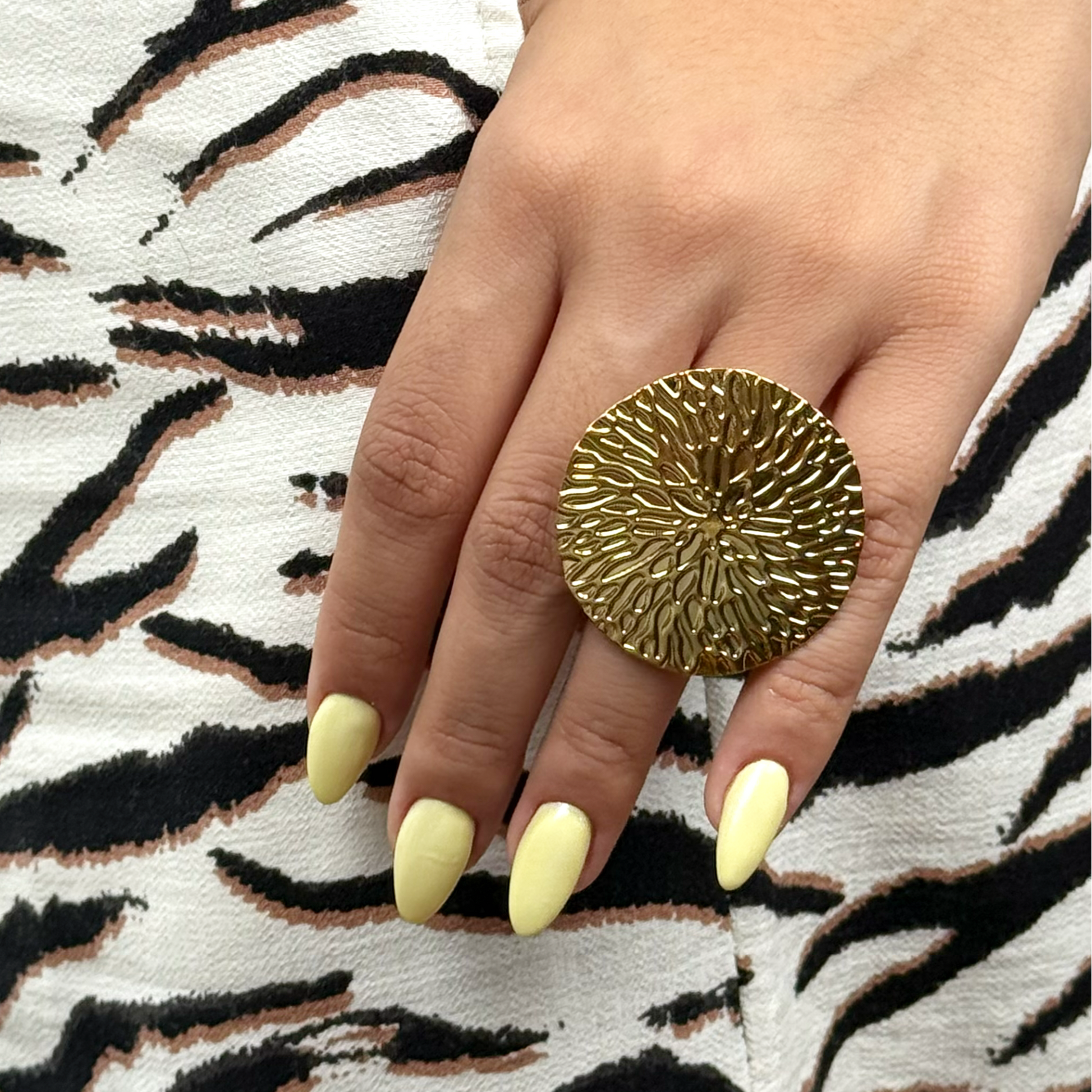 Golden statement ring inspired by ocean reefs.
