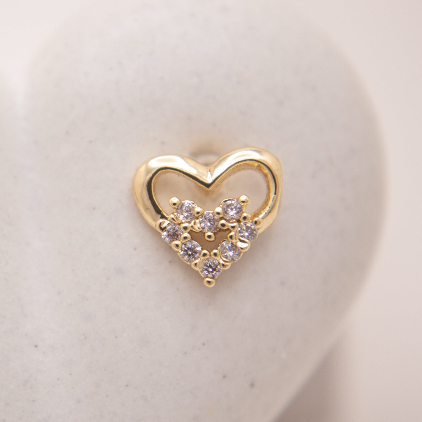 Romantic gold stud earrings with heart shape design.