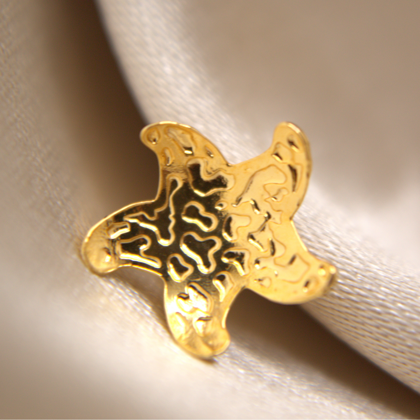 Elegant gold starfish studs with high-shine rhodium-plated finish.