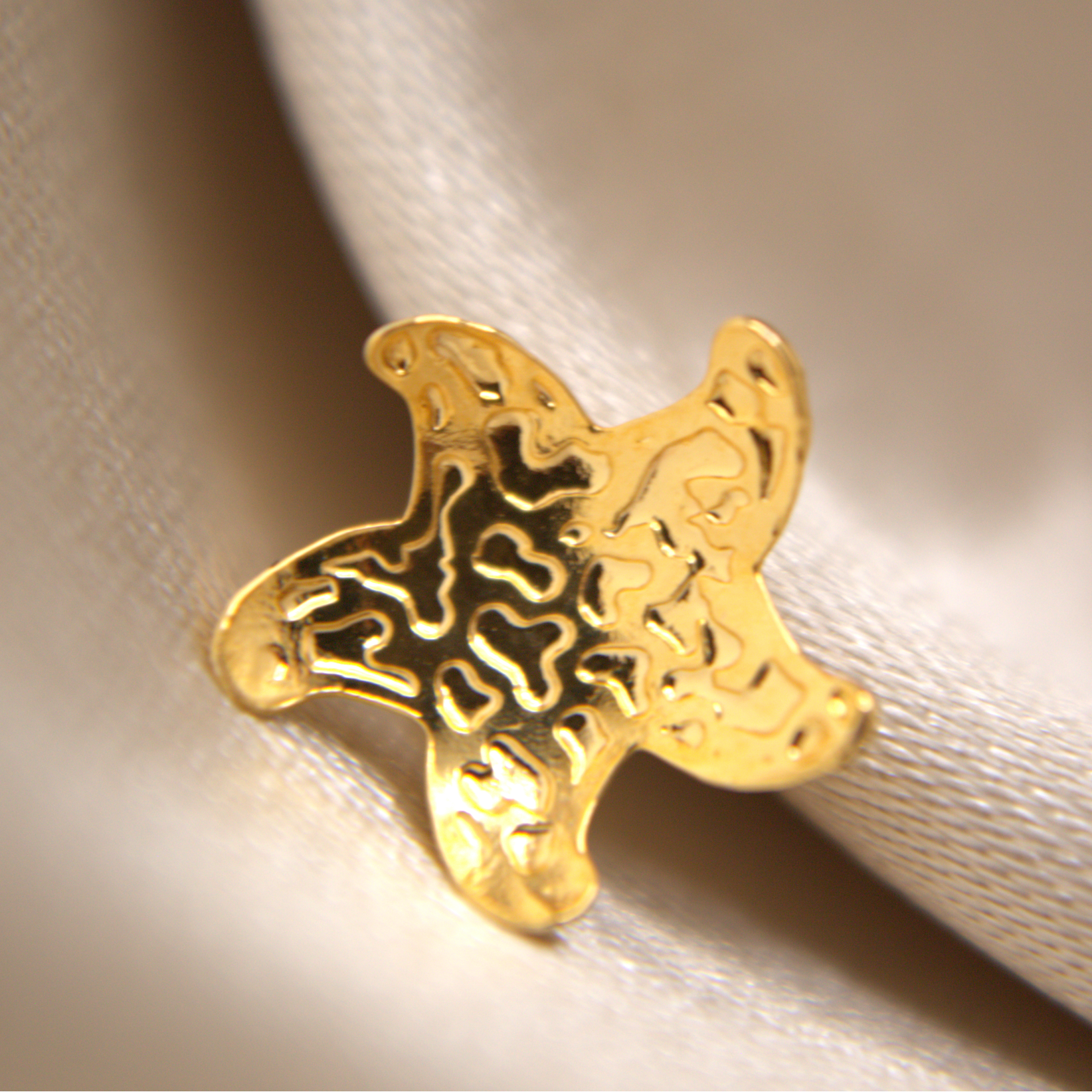 Elegant gold starfish studs with high-shine rhodium-plated finish.
