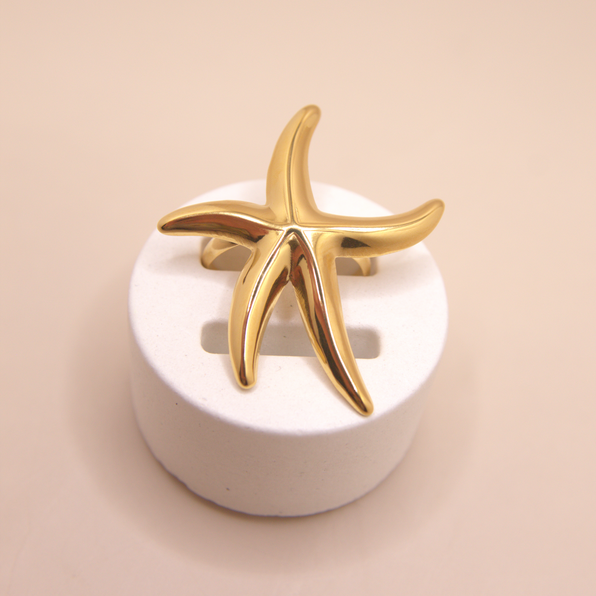 Ocean-inspired statement ring with golden starfish design.