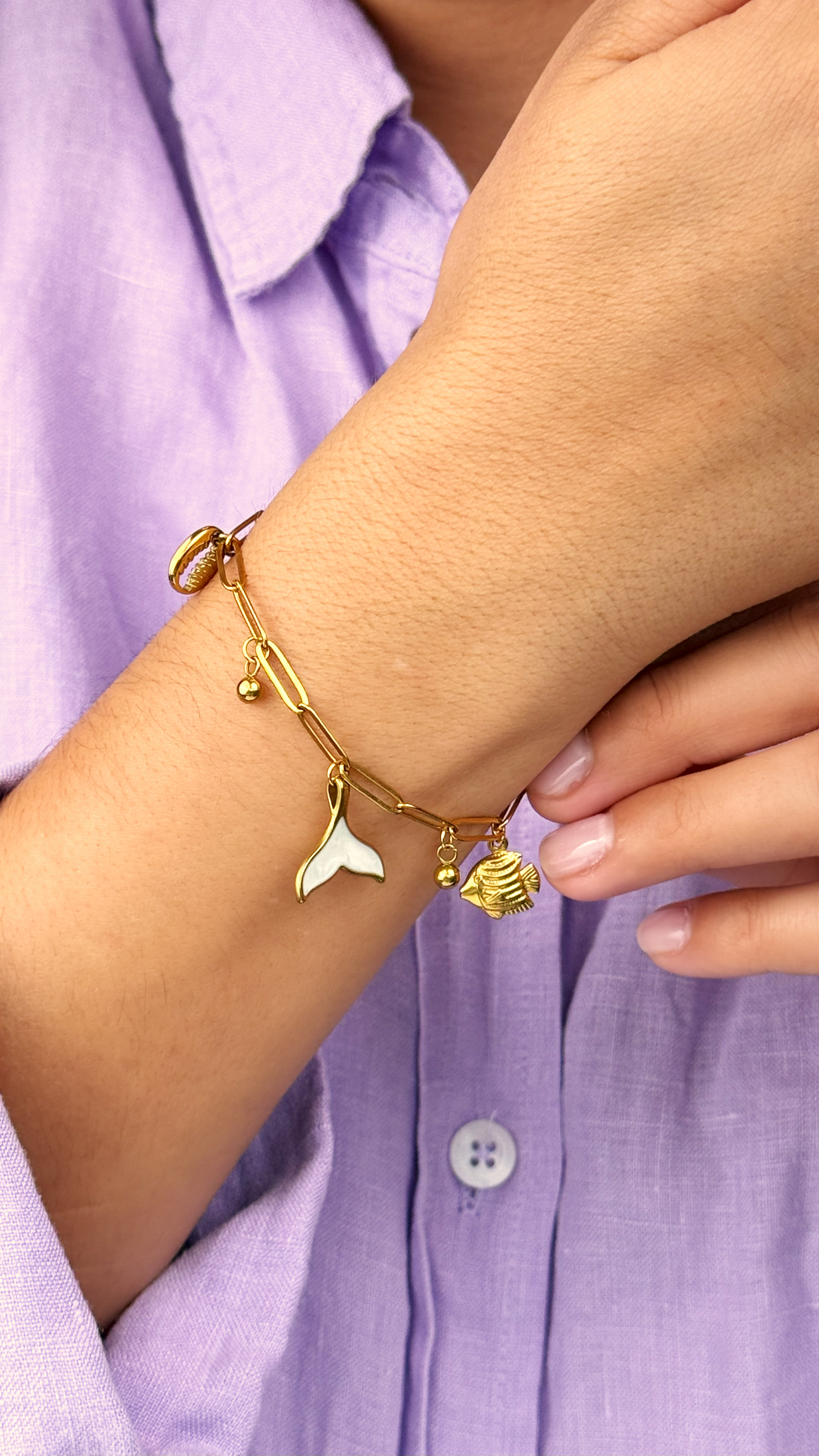 Golden Siren’s Whisper Bracelet featuring shell, fish, and enamel mermaid tail charm