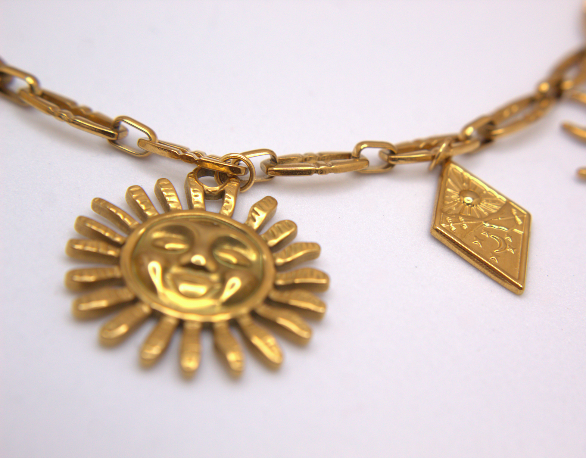 Gold PVD stainless steel necklace with layered sun charms, trendy statement jewelry.