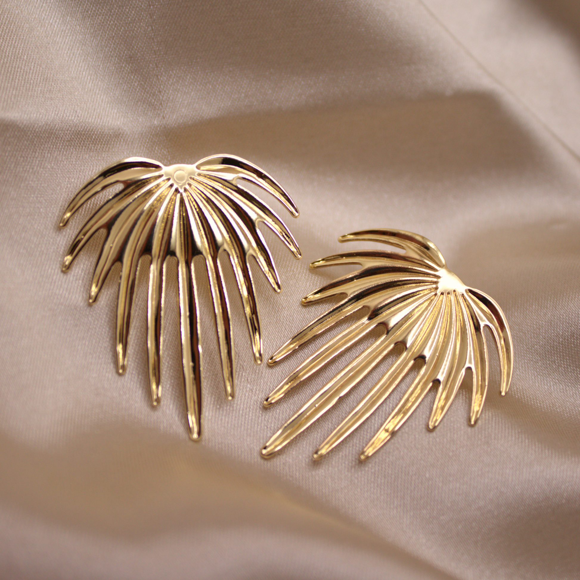 Gold palm-inspired earrings with tropical leaf design by Selva&Co.