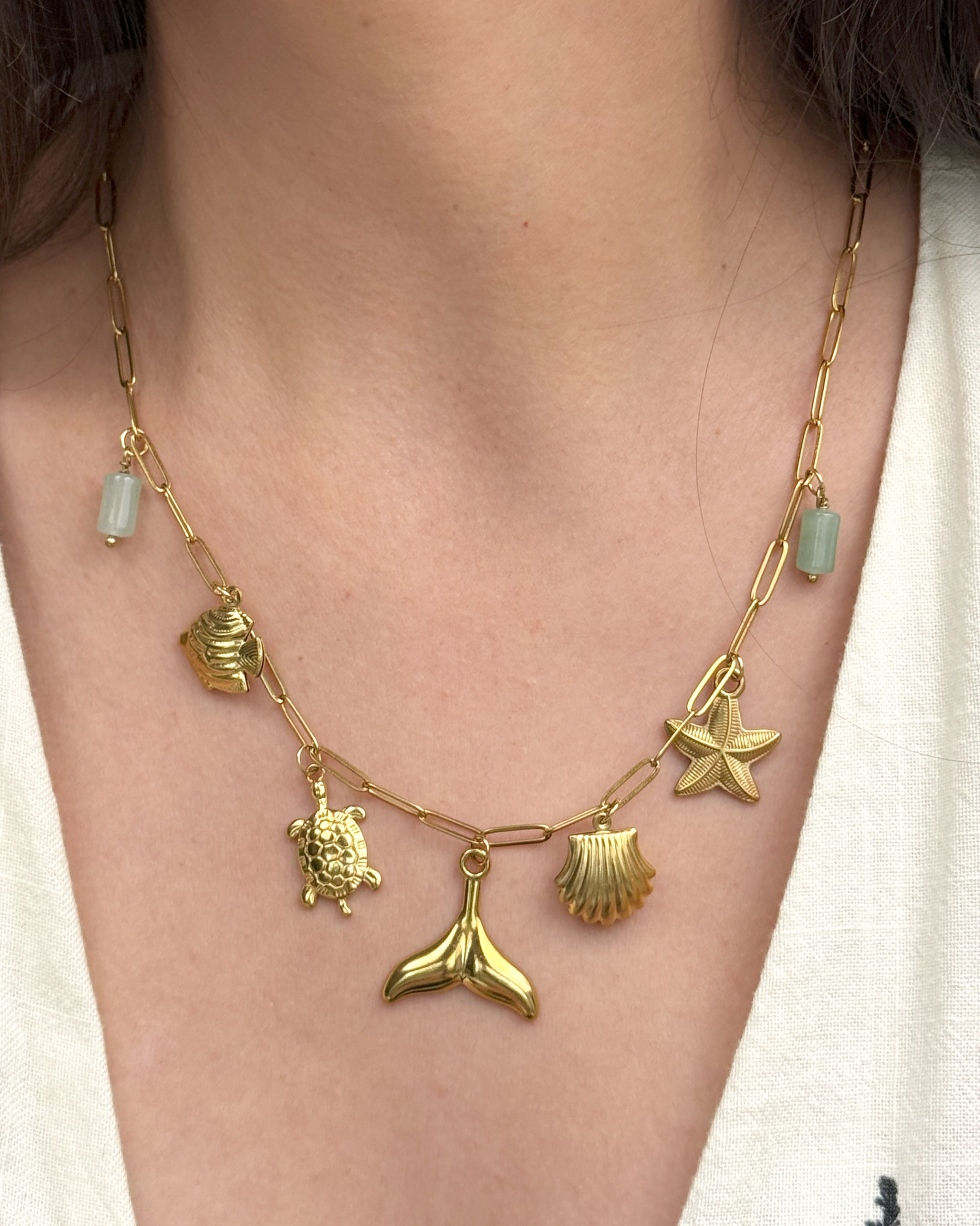 Waterproof gold necklace with whale tail pendant and marine charms