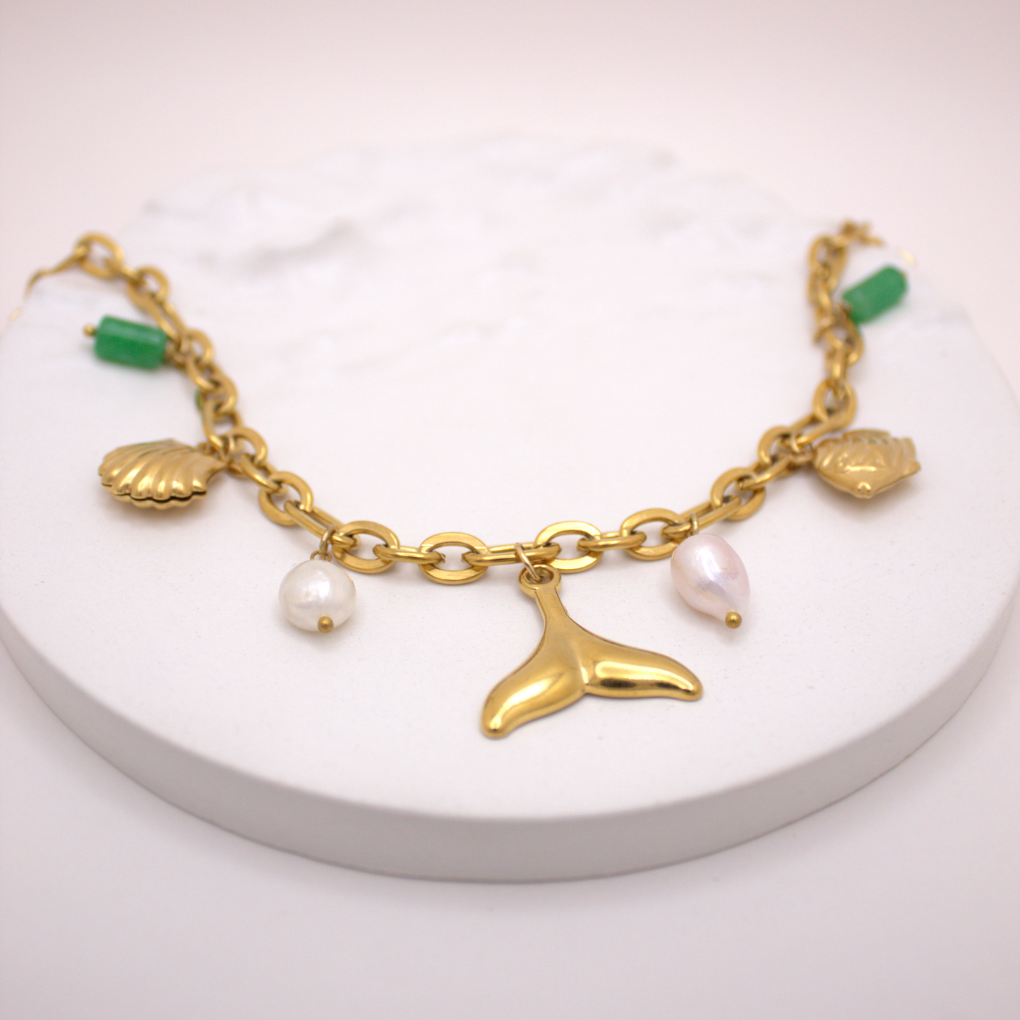 Golden link chain necklace featuring sea-inspired charms and pearls