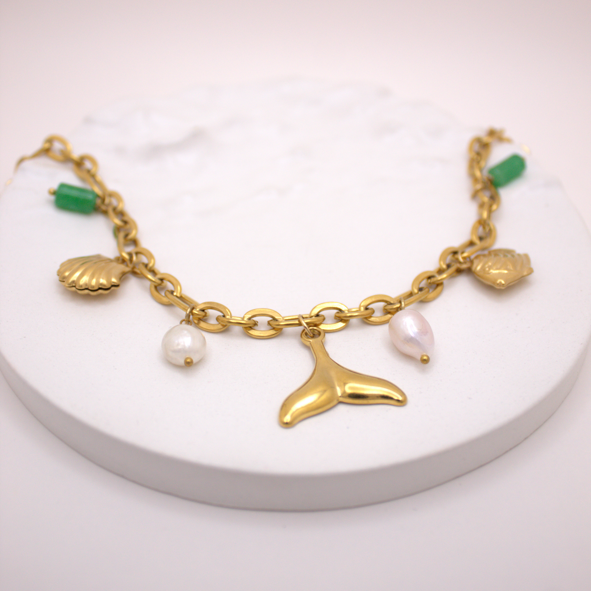 Golden link chain necklace featuring sea-inspired charms and pearls