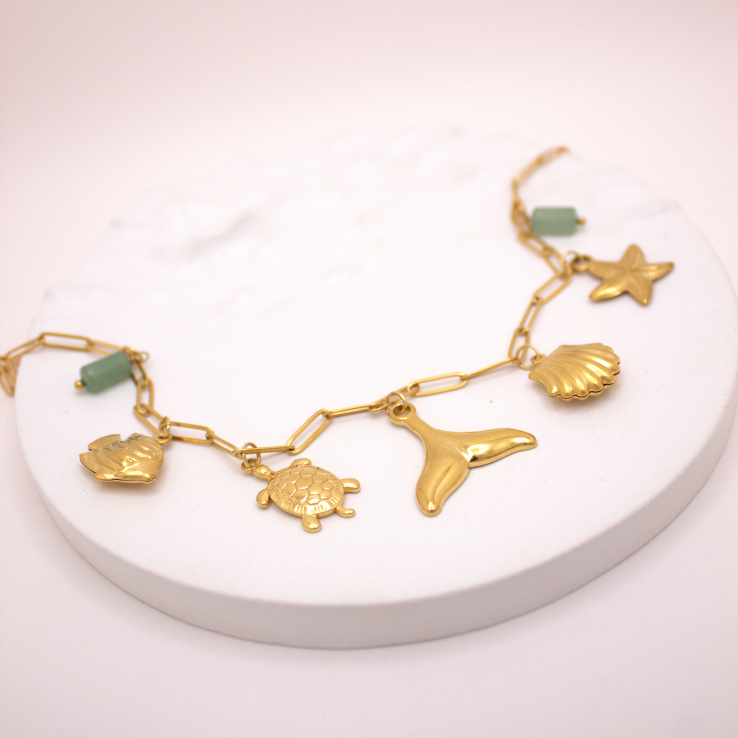 Gold ocean charm necklace featuring sea creatures and natural stones